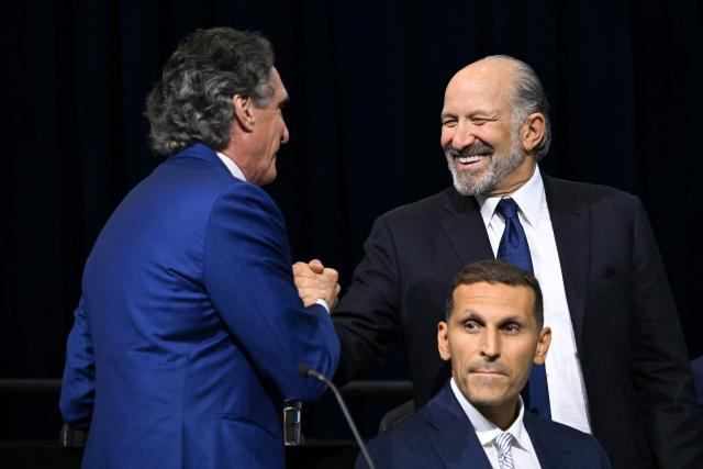 US Secretary of the Interior Doug Burgum (L) and US Secretary of Commerce Howard Lutnick (R) shake hands as CEO and Managing Director of Mubadala Investment Company Khaldoon Al-Mubarak looks on during the Pennsylvania Energy and Innovation Summit on the campus of Carnegie Mellon University in Pittsburgh, Pennsylvania on July 15, 2025. (Photo by ANDREW CABALLERO-REYNOLDS / AFP)