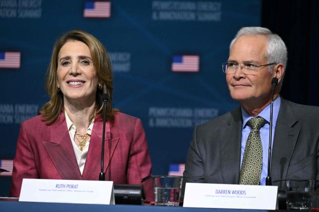 Darren Wodds (R) and Ruth Porat, president and chief investment officer of Alphabet and its subsidiary Google, attend the inaugural Pennsylvania Energy and Innovation Summit on the campus of Carnegie Mellon University in Pittsburgh, Pennsylvania, on July 15, 2025. (Photo by ANDREW CABALLERO-REYNOLDS / AFP)