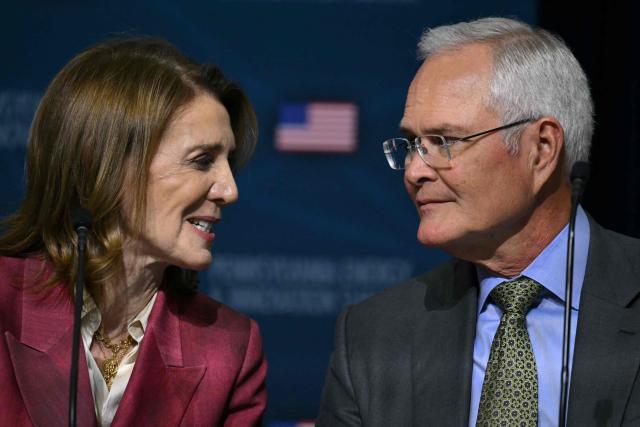 Darren Wodds (R) speaks with Ruth Porat, president and chief investment officer of Alphabet and its subsidiary Google, at the inaugural Pennsylvania Energy and Innovation Summit on the campus of Carnegie Mellon University in Pittsburgh, Pennsylvania, on July 15, 2025. (Photo by ANDREW CABALLERO-REYNOLDS / AFP)