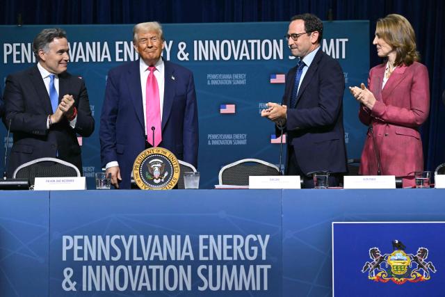 US President Donald Trump (2L) is applauded by (L/R) US Senator Dave McCormick (R-PA), CEO of Blackstone Group Jon Gray and President and chief investment officer of Google Ruth Porat as he arrives for the Pennsylvania Energy and Innovation Summit on the campus of Carnegie Mellon University in Pittsburgh, Pennsylvania on July 15, 2025. (Photo by ANDREW CABALLERO-REYNOLDS / AFP)