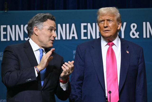 US President Donald Trump (R) is applauded by US Senator Dave McCormick (R-PA) as he arrives for the Pennsylvania Energy and Innovation Summit on the campus of Carnegie Mellon University in Pittsburgh, Pennsylvania on July 15, 2025. (Photo by ANDREW CABALLERO-REYNOLDS / AFP)