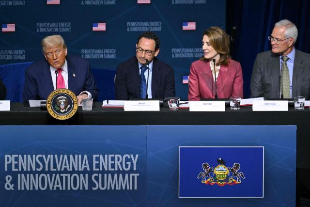 (L/R) US President Donald Trump speaks, flanked by CEO of Blackstone Group Jon Gray, President and Chief Investment Officer of Google Ruth Porat and CEO of ExxonMobil Darren Woods, during the Pennsylvania Energy and Innovation Summit on the campus of Carnegie Mellon University in Pittsburgh, Pennsylvania on July 15, 2025. (Photo by ANDREW CABALLERO-REYNOLDS / AFP)