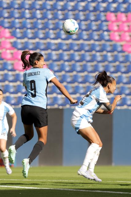 Uruguay's midfielder #09 Pamela Gonzalez and Argentina's forward #22 Betina Soriano fight for the ball during the Women's Copa America 2025 football match between Uruguay and Argentina at the Independiente del Valle complex in Quito on July 15, 2025. (Photo by ARMANDO PRADO / AFP)