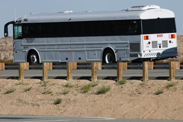 A TransCor America, LLC bus parked outside The CoreCivic, Inc. California City Immigration Processing Center in the Kern County desert ahead of the facility reopening as a federal immigrant detention facility under contract with the US Immigration and Customs Enforcement (ICE) in California City, California on July 10, 2025. (Photo by Patrick T. Fallon / AFP)