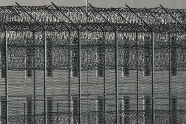 Security fencing surrounds the CoreCivic, Inc. California City Immigration Processing Center in the Kern County desert ahead of the facility reopening as a federal immigrant detention facility under contract with the US Immigration and Customs Enforcement (ICE) in California City, California on July 10, 2025. (Photo by Patrick T. Fallon / AFP)