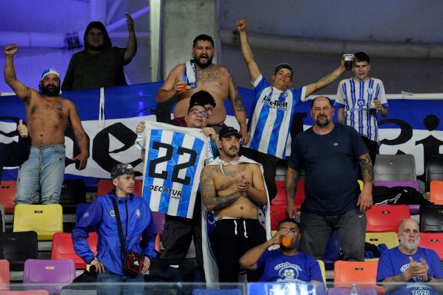 Fans of Cerro Largo cheer for their team during the Copa Sudamericana knockout round play-off football match between Argentina's Central Cordoba and Uruguay's Cerro Largo at the Madre de Ciudades stadium in Santiago del Estero, Argentina on July 15, 2025. (Photo by Eduardo RAPETTI / AFP)