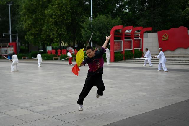 A child practise Chinese martial art at a square in Beijing on July 16, 2025. (Photo by WANG Zhao / AFP)