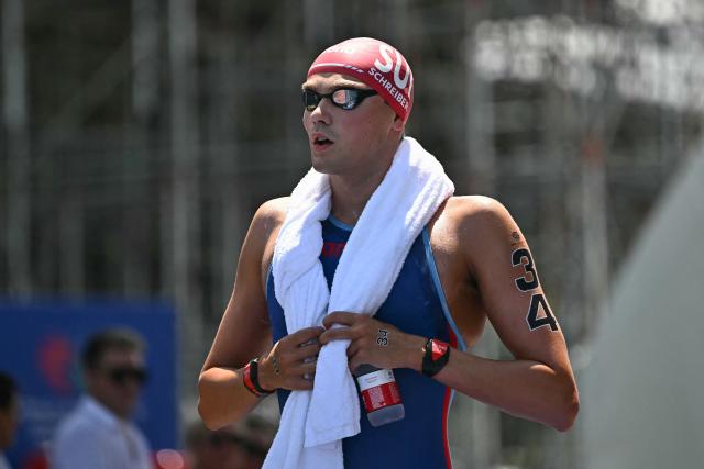 Switzerland's swimmer Christian Schreiber arrives for the final of the men's 10km open water swimming event during the 2025 World Aquatics Championships at Sentosa Island in Singapore on July 16, 2025. (Photo by Manan VATSYAYANA / AFP)