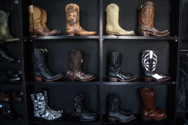 Leather boots are displayed at the showroom of Tegep Boots, a popular Indonesian handmade leather boots maker with many dedicated customers in the United States and Europe, in Bandung, West Java on July 15, 2025. At a leather boot shop in the Indonesian city of Bandung, workers handle an order from Texas but owner Etnawati Melani says she fears such business will dwindle when US president Donald Trump's tariffs hit exports. (Photo by Timur MATAHARI / AFP) / TO GO WITH AFP STORY: Indonesia-economy-trade-US, by Yuli Krisna