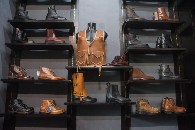 Leather boots and other products are displayed at the showroom of Tegep Boots, a popular Indonesian handmade leather boots maker with many dedicated customers in the United States and Europe, in Bandung, West Java on July 15, 2025. At a leather boot shop in the Indonesian city of Bandung, workers handle an order from Texas but owner Etnawati Melani says she fears such business will dwindle when US president Donald Trump's tariffs hit exports. (Photo by Timur MATAHARI / AFP) / TO GO WITH AFP STORY: Indonesia-economy-trade-US, by Yuli Krisna