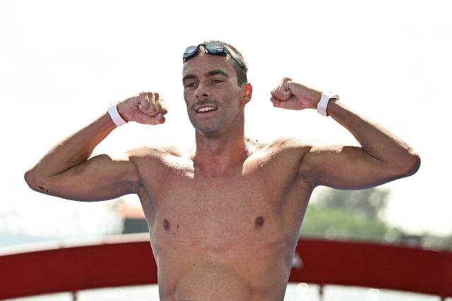Italy's swimmer Gregorio Paltrinieri celebrates finishing second in the final of the men's 10km open water swimming event during the 2025 World Aquatics Championships at Sentosa Island in Singapore on July 16, 2025. (Photo by Manan VATSYAYANA / AFP)
