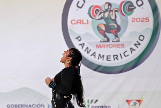 Panama's Kelly Aparicio reacts as she competes in the 69 kg category during the 2025 Pan American Weightlifting Championships at Miguel Calero Coliseum in Cali, Colombia on July 16, 2025. (Photo by JOAQUIN SARMIENTO / AFP)