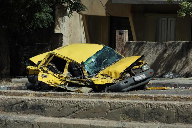 A destroyed car lies on the side of a street in Syria's predominantly-Druze southern Sweida city after the withdrawal of government troops from the area on July 17, 2025. Syrian forces pulled out of the Druze heartland province of Sweida on July 17 on orders from the Islamist-led government, AFP journalists reported from the provincial capital. The southern province has been gripped by deadly sectarian bloodshed since July 13, with hundreds reportedly killed in clashes pitting Druze fighters against Sunni Bedouin tribes and the army and its allies. (Photo by Shadi AL-DUBAISI / AFP)