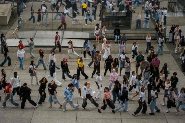 Young people participate in a mass dancing event at the La Defense business district, on the western outskirts of Paris on July 17, 2025. (Photo by Dimitar DILKOFF / AFP)