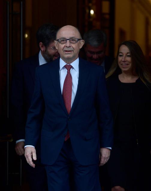 (FILES) Spanish Finance Minister, Cristobal Montoro arrives to present the 2017 budget, at the Congress of Deputies in Madrid on April 4, 2017. Former Spanish Finance Minister Cristobal Montoro, a member of the Popular Party (PP), left the conservative party on July 17, 2025 after being charged in a corruption case, according to the PP. This decision follows the indictment on July 16, 2025 of Montoro and thirty other people for "bribery, fraud against the public administration, malfeasance, influence peddling, prohibited negotiations, business corruption, and document falsification," according to a ruling by a Tarragona judge. (Photo by PIERRE-PHILIPPE MARCOU / AFP)