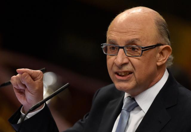 (FILES) Spain's Treasury and Public Administrations Minister Cristobal Montoro delivers a speech during the 2016 budget draft debate at the Spanish parliament in Madrid on August 25, 2015. Former Spanish Finance Minister Cristobal Montoro, a member of the Popular Party (PP), left the conservative party on July 17, 2025 after being charged in a corruption case, according to the PP. This decision follows the indictment on July 16, 2025 of Montoro and thirty other people for "bribery, fraud against the public administration, malfeasance, influence peddling, prohibited negotiations, business corruption, and document falsification," according to a ruling by a Tarragona judge. (Photo by GERARD JULIEN / AFP)