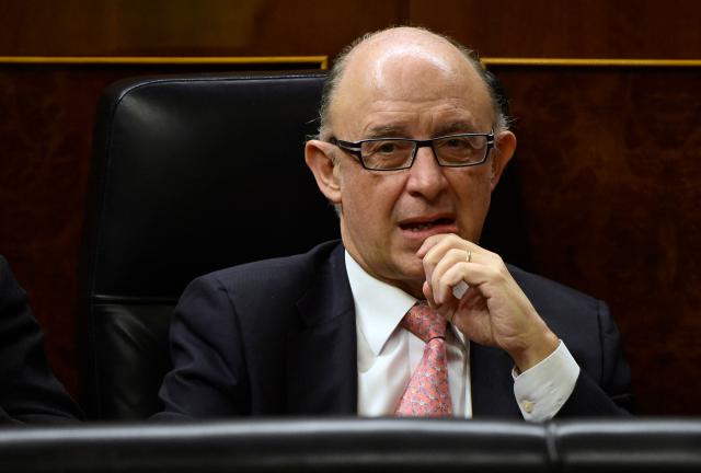 (FILES) Spain's Finance Minister Cristobal Montoro gestures during a debate on the state of the nation at the Congress of Deputies in Madrid on February 24, 2015. Former Spanish Finance Minister Cristobal Montoro, a member of the Popular Party (PP), left the conservative party on July 17, 2025 after being charged in a corruption case, according to the PP. This decision follows the indictment on July 16, 2025 of Montoro and thirty other people for "bribery, fraud against the public administration, malfeasance, influence peddling, prohibited negotiations, business corruption, and document falsification," according to a ruling by a Tarragona judge. (Photo by Pierre-Philippe MARCOU / AFP)