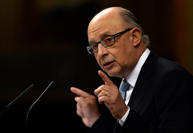(FILES) Spain's Treasury and Public Administrations Minister Cristobal Montoro delivers a speech during the 2016 budget draft debate at the Spanish parliament in Madrid on August 25, 2015. AFP PHOTO / GERARD JULIEN. Former Spanish Finance Minister Cristobal Montoro, a member of the Popular Party (PP), left the conservative party on July 17, 2025 after being charged in a corruption case, according to the PP. This decision follows the indictment on July 16, 2025 of Montoro and thirty other people for "bribery, fraud against the public administration, malfeasance, influence peddling, prohibited negotiations, business corruption, and document falsification," according to a ruling by a Tarragona judge. (Photo by GERARD JULIEN / AFP)