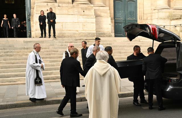 Pallbearers load the coffin of French TV host Thierry Ardisson in a hearse at the end of his funeral at Saint-Roch Church in Paris on July 17, 2025. Host and producer Thierry Ardisson, the French TV star nicknamed ‘The Man in Black’, died in Paris on July 14, 2025 aged 76 from liver cancer, his wife and children told AFP in a statement. (Photo by Bertrand GUAY / AFP)