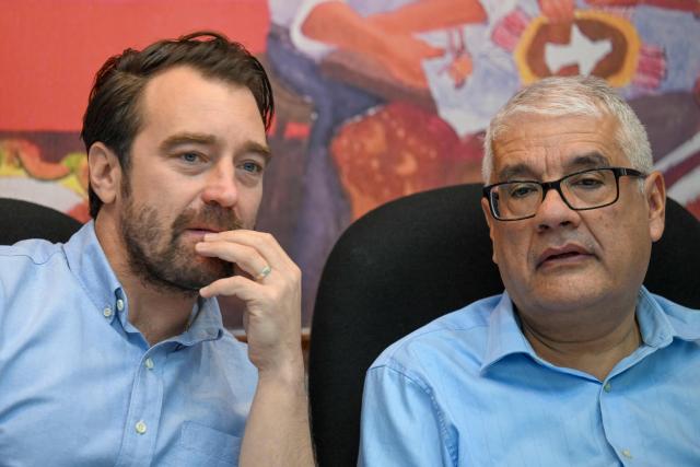 Executive director of the NGO Cristosal, Noah Bullock (L) and Abraham Abrego, director of the strategic litigation of the human rights group Cristosal, chat before a press conference in Guatemala City, on July 17, 2025. NGO Cristosal, a leading rights group investigating corruption in El Salvador, said on July 17, 2025, it had been forced into exile due to "escalating repression" by President Nayib Bukele's administration. (Photo by JOHAN ORDONEZ / AFP)