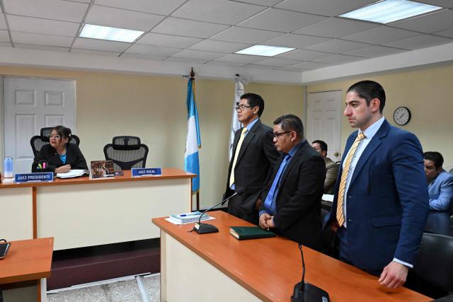 Former anti-corruption prosecutors Carlos Perez (3rd-R), Rafael Chilel (2nd-R), and Stuardo Campo (R) listen to the sentence during a hearing at the Palace of Justice in Guatemala City on July 18, 2025. A criminal court in Guatemala acquitted three former anti-corruption prosecutors on Friday, who were accused of failing to fulfill their duties, victims of proceedings initiated by the prosecution, and criticized by the international community. (Photo by JOHAN ORDONEZ / AFP)