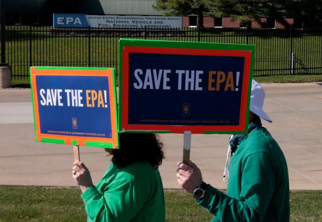 (FILES) Demonstrators march during a "Hands off the EPA" (Environmental Protection Agency) rally outside the EPA offices in Ann Arbor, Michigan, on Earth Day, April 22, 2025. The US Environmental Protection Agency said on July 18, 2025 that it was moving ahead with plans to axe its workforce by more than 3,700 employees, as part of sweeping government cuts under President Donald Trump's second term. (Photo by JEFF KOWALSKY / AFP)