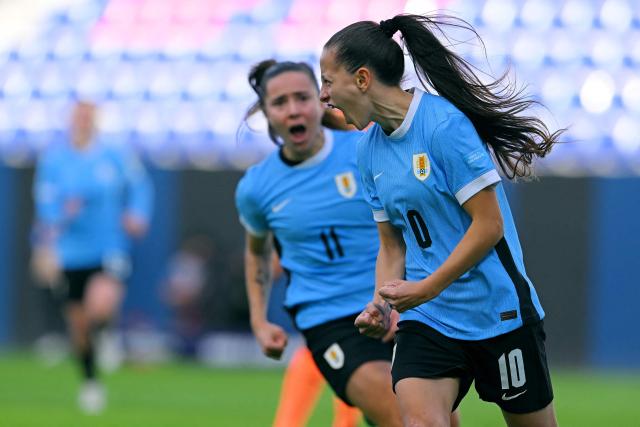 Uruguay's forward #10 Belen Aquino (R) celebrates scoring his team's first goal during the Women's Copa America 2025 football match between Uruguay and Peru at the IDV stadium in Quito on July 18, 2025. (Photo by Rodrigo BUENDIA / AFP)