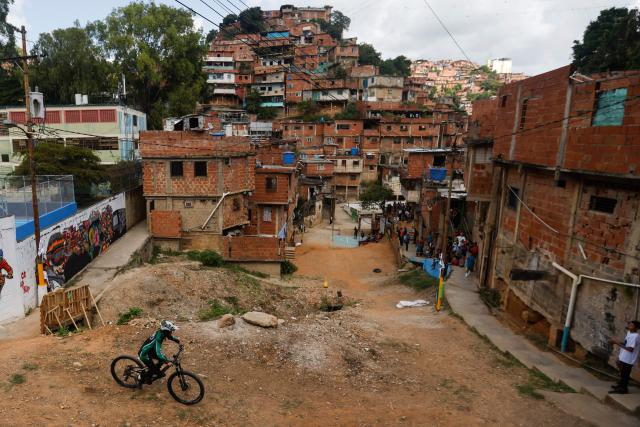 A downhill rider participates in the Petare en Alta urban downhill competition in Petare, Miranda state, Venezuela on July 18, 2025. (Photo by Pedro MATTEY / AFP)