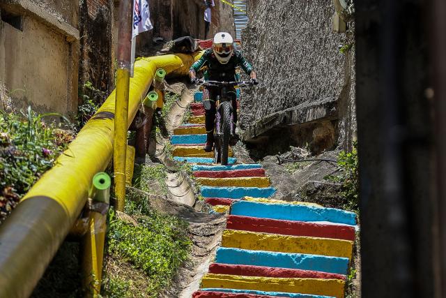 A downhill rider participates in the Petare en Alta urban downhill competition in Petare, Miranda state, Venezuela on July 18, 2025. (Photo by Pedro MATTEY / AFP)