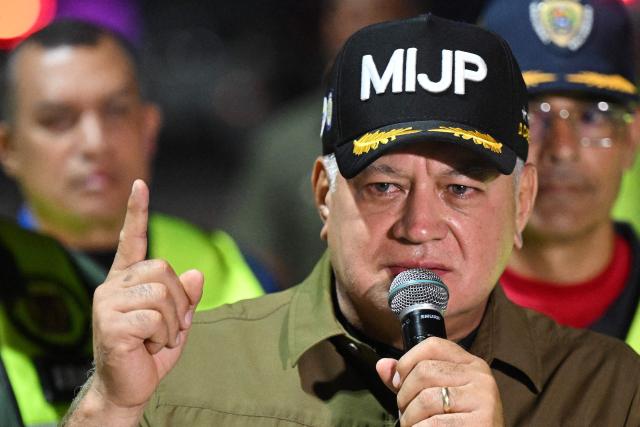 Venezuela's Minister of Interior Relations, Justice and Peace, Diosdado Cabello, speaks to the press as Venezuelan migrants who were jailed in El Salvador get off a plane at Simon Bolivar International Airport in Maiquetia, Venezuela on July 18, 2025. El Salvador freed scores of Venezuelans deported from the United States to a notorious maximum security prison, the outcome of a highly coordinated prisoner swap between Caracas and Washington on July 18, 2025. (Photo by Federico PARRA / AFP)
