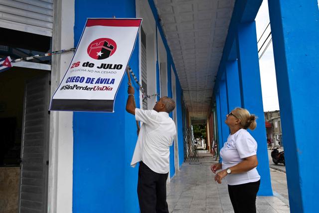 Cubans decorate a street in tribute to the 72nd anniversary of the assault on the Moncada Barracks in 1953, in Ciego de Avila province, Cuba on July 23, 2025. The Cuban government on July 26 will commemorate the 72nd anniversary of the guerrilla assault on the Moncada Barracks, widely regarded as the beginning of the Cuban Revolution. (Photo by YAMIL LAGE / AFP)