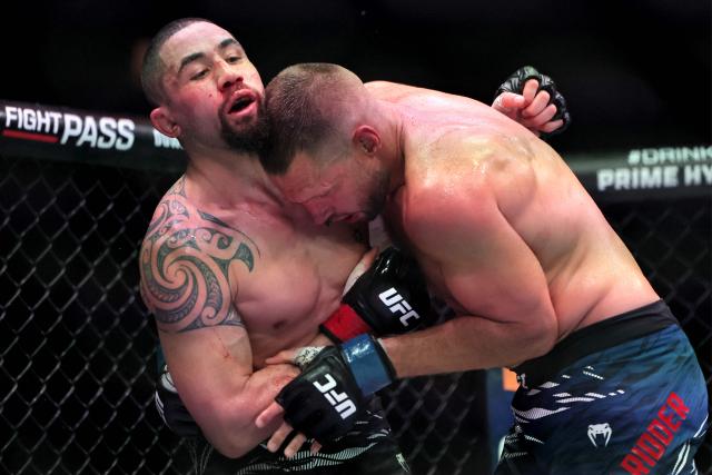 Australia and New Zealand's Robert Whittaker and the Netherlands' Reinier de Ridder compete in their men's middleweight fight at the UFC Fight Night event at Etihad Arena in Abu Dhabi on July 26, 2025. (Photo by Fadel SENNA / AFP)