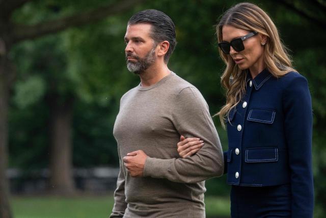 Donald Trump Jr. walks with Bettina Anderson as they arrive on the South Lawn of the White House in Washington, DC, on July 29, 2025. Trump returned to Washington following a trip to Scotland. (Photo by Jim WATSON / AFP)