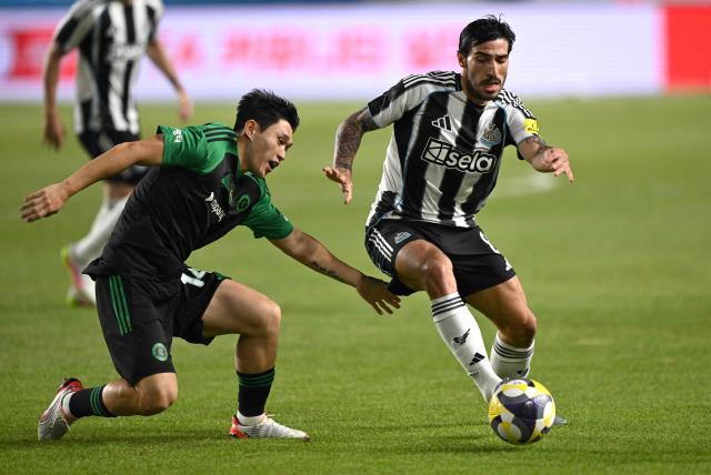 Newcastle United's Sandro Tonali (R) fights for the ball with Team K-League's Lee Dong-gyeong (L) during the friendly football match between English Premier League football club Newcastle United and South Korean K League stars, Team K-League, in Suwon on July 30, 2025. (Photo by Jung Yeon-je / AFP)