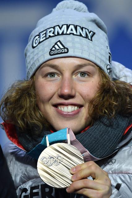 (FILES) Germany's bronze medallist Laura Dahlmeier poses on the podium during the medal ceremony for the Biathlon Women's 15km Individual at the Pyeongchang Medals Plaza during the Pyeongchang 2018 Winter Olympic Games in Pyeongchang on February 16, 2018. German double biathlon champion Laura Dahlmeier was confirmed dead on July 30, 2025 after she was seriously injured by a rockfall on a Pakistani mountain. The dangerous nature of the site made rescue efforts "impossible", her agency said in a statement issued on July 30, 2025, which confirmed her death. "Rescue efforts to recover her failed and the operation was suspended," the statement continued. The accident happened around midday on July 28, 2025 at an altitude of 5,700 metres on Laila Peak in the Karakoram range, according to a statement from her team on her official social media sites. (Photo by Martin BERNETTI / AFP)