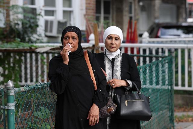 Two women look on outside the Parkchester Jame Masjid during the funeral for NYPD officer Didarul Islam in the Bronx borough of New York City on July 31, 2025. Islam was one of four people killed when a shooter opened fire in a New York skyscraper before committing suicide on July 28. (Photo by TIMOTHY A. CLARY / AFP)