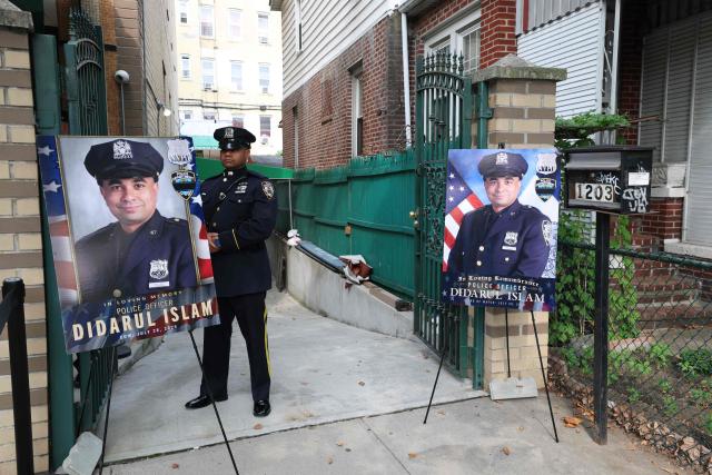 A police officer stands outside the Parkchester Jame Masjid for the funeral for NYPD officer Didarul Islam in the Bronx borough of New York City on July 31, 2025. Islam was one of four people killed when a shooter opened fire in a New York skyscraper before committing suicide on July 28. (Photo by TIMOTHY A.CLARY / AFP)