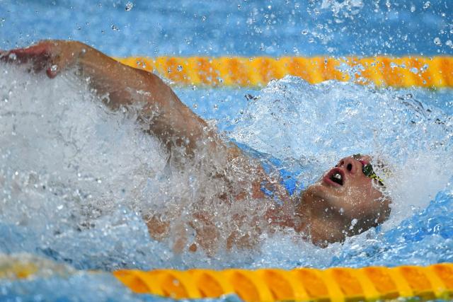 US' swimmer Quintin McCarty competes in  a heat of the men's 50m backstroke swimming event during the 2025 World Aquatics Championships in Singapore on August 2, 2025. (Photo by Oli SCARFF / AFP)