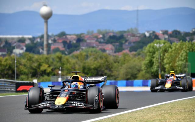 Red Bull's Dutch driver Max Verstappen (L) and RB's Japanese driver Yuki Tsunoda race during the third practice session ahead of the Formula One Hungarian Grand Prix at the Hungaroring circuit in Mogyorod near Budapest, Hungary, on August 2, 2025. (Photo by Ferenc ISZA / AFP)
