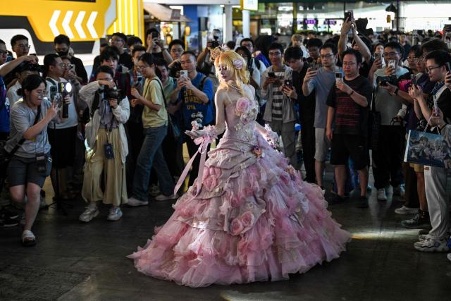 A cosplayer poses for pictures during the China Digital Entertainment Expo and Conference known as ChinaJoy, at the Shanghai New International Expo Centre in Shanghai on August 4, 2025. (Photo by Hector RETAMAL / AFP)