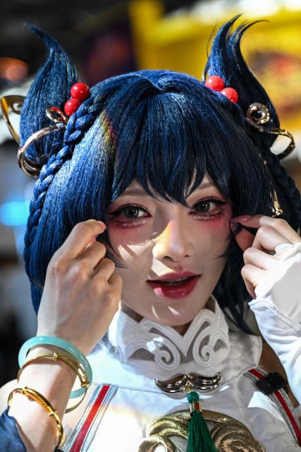 A cosplayer poses during the China Digital Entertainment Expo and Conference known as ChinaJoy, at the Shanghai New International Expo Centre in Shanghai on August 4, 2025. (Photo by Hector RETAMAL / AFP)