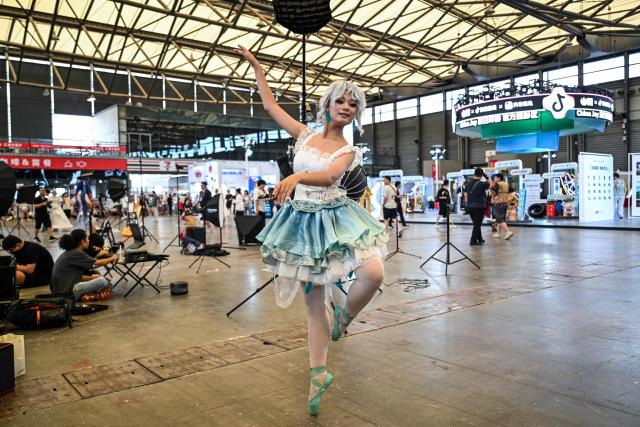 A cosplayer poses for pictures during the China Digital Entertainment Expo and Conference known as ChinaJoy, at the Shanghai New International Expo Centre in Shanghai on August 4, 2025. (Photo by Hector RETAMAL / AFP)