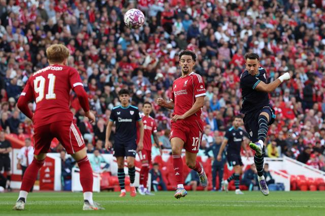 Athletic Bilbao's Spanish striker #07 Alex Berenguer (R) shoots but the shot goes over the bar during the first of two pre season friendly football matches between Liverpool and Athletic Bilbao at Anfield in Liverpool, north west England on August 4, 2025. (Photo by Darren Staples / AFP)