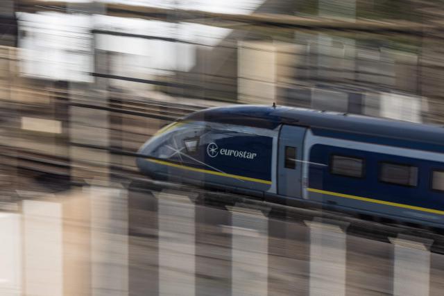 (FILES) A Eurostar passenger train arrives to enter the Channel Tunnel, operated by the company Eurotunnel, in Coquelles, northern France, on April 4, 2025. At least 17 Eurostar trains connecting Paris with London and continental Europe were cancelled on August 4, 2025 after an electrical fault on the high speed line in northern France, the train company said. (Photo by Sameer Al-DOUMY / AFP)