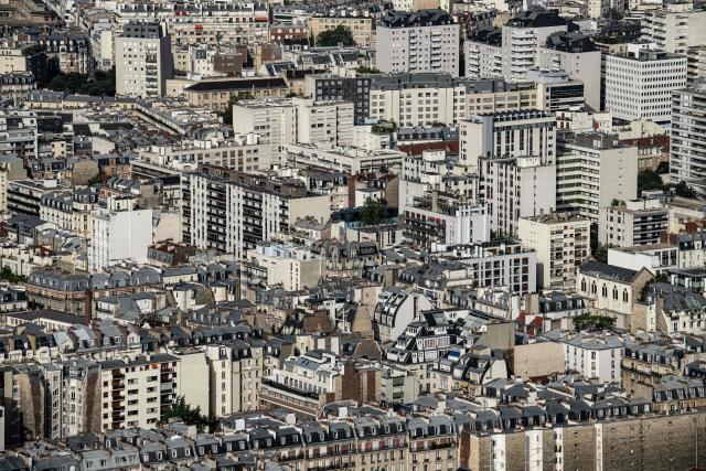 (FILES) This photograph taken from the panoramic terrace of the Montparnasse tower, on September 6, 2023 shows the zinc rooftops of Haussmannian buildings in Paris, amid modern buildings. Some resist, others crack: Paris does not have a culture of individual air conditioning, but with the intensification of heat waves, the issue is becoming increasingly pressing and poses a dilemma for those who are aware of the damage it causes.‘It was up to 41 degrees in my home during the last heatwave. I didn't think that was possible,’ sighs Marion Laruste, who lives in an attic in the north-east of the capital. (Photo by MIGUEL MEDINA / AFP)