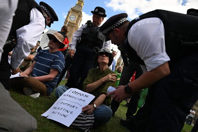 Police officers make an arrest at a "Lift The Ban" demonstration in support of the proscribed group Palestine Action, calling for the recently imposed ban to be lifted, in Parliament Square, central London, on August 9, 2025. Organisers expect at least 500 people to turn up to a new demonstration in support of Palestine Action today, and police have warned all demonstrators could face arrest. Palestine Action was proscribed under the 2000 Terrorism Act. (Photo by Chris J Ratcliffe / AFP)