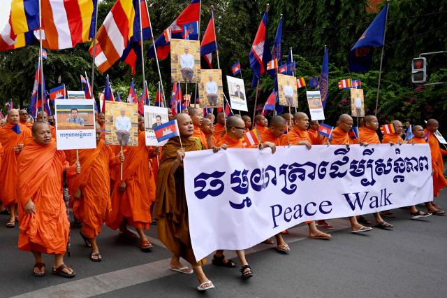 Cambodian Buddhist monks take part in a march for peace in Phnom Penh on August 10, 2025, following a border conflict with Thailand. (Photo by TANG CHHIN Sothy / AFP)