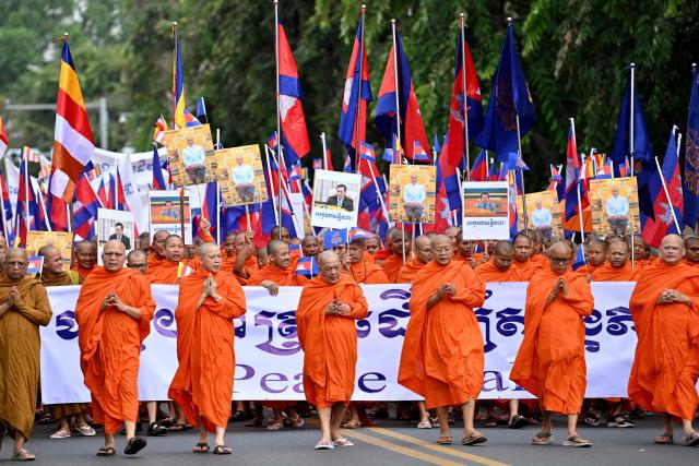 Cambodian Buddhist monks take part in a march for peace in Phnom Penh on August 10, 2025, following a border conflict with Thailand. (Photo by TANG CHHIN Sothy / AFP)
