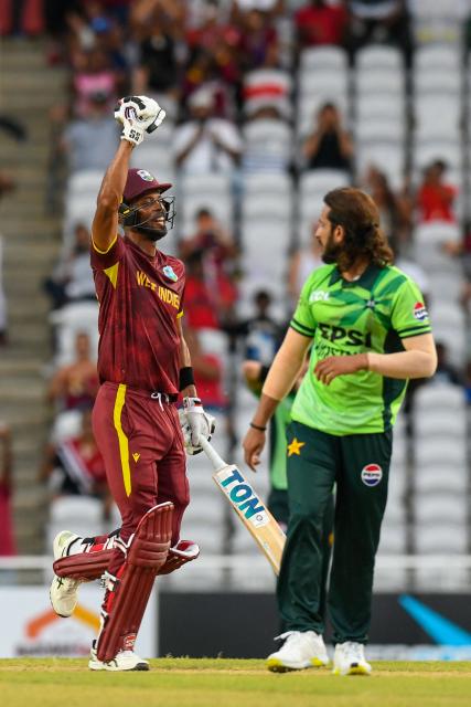 Roston Chase (L) of West Indies celebrate winning the second One Day International (ODI) cricket match between West Indies and Pakistan at Brian Lara Cricket Academy in Tarouba, San Fernando, Trinidad and Tobago on August 10, 2025. (Photo by Randy Brooks / AFP)