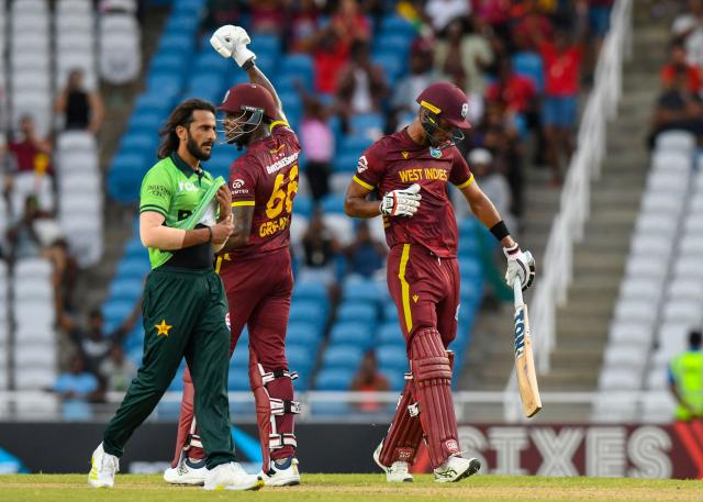 Hasan Ali (L) of Pakistan walks off the field while Justin Greaves (C) and Roston Chase (R) of West Indies celebrate winning the second One Day International (ODI) cricket match between West Indies and Pakistan at Brian Lara Cricket Academy in Tarouba, San Fernando, Trinidad and Tobago on August 10, 2025. (Photo by Randy Brooks / AFP)